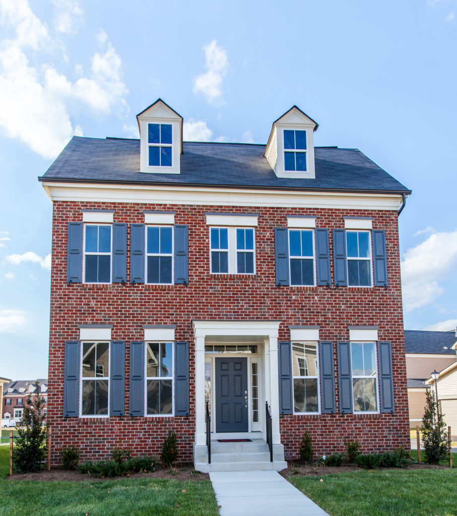 Blue Vantage shutters on brick Colonial home