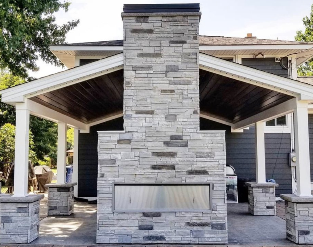 Two-sided outdoor fireplace made with Versetta Stone
